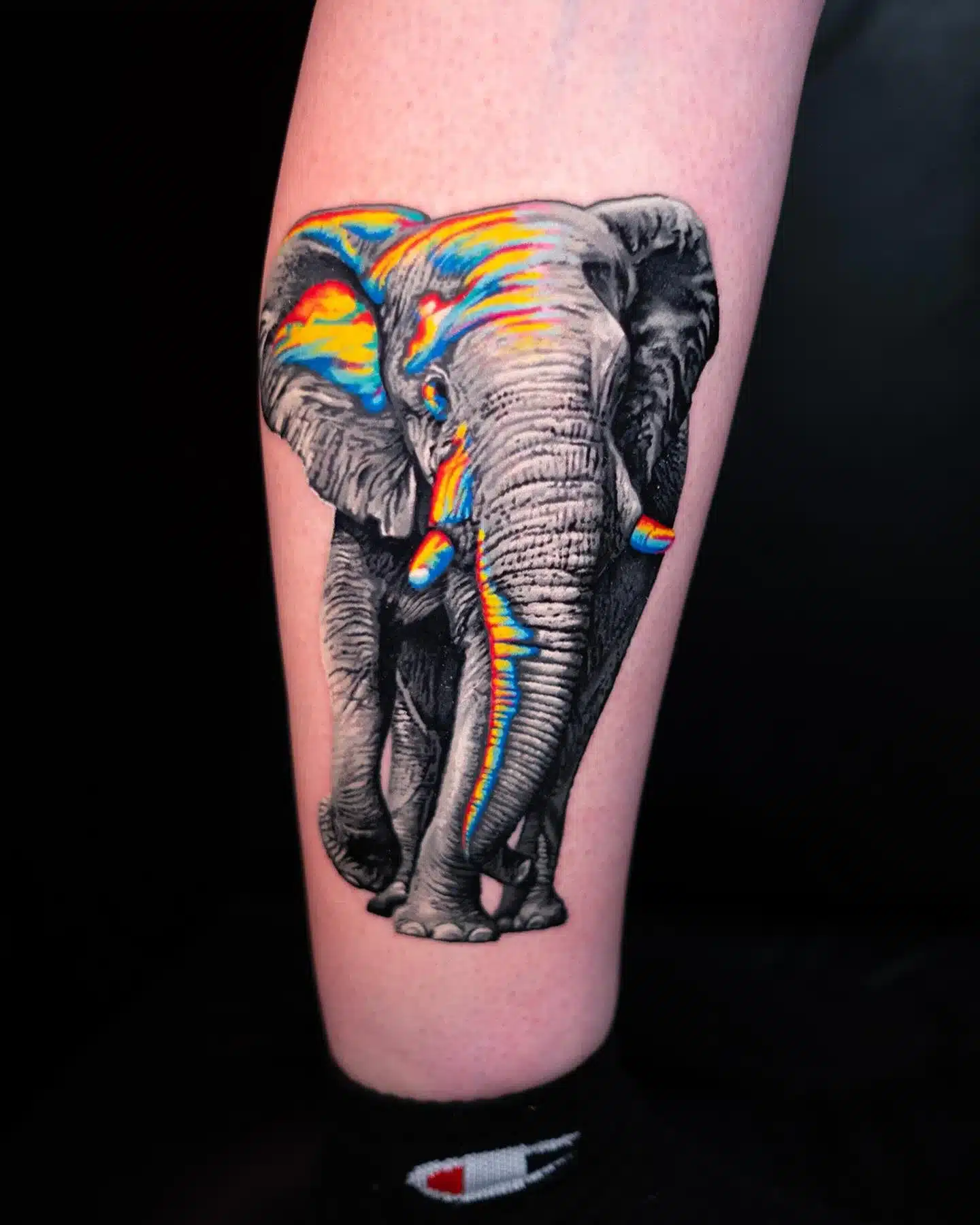 calf tattoo with a pixel glitch