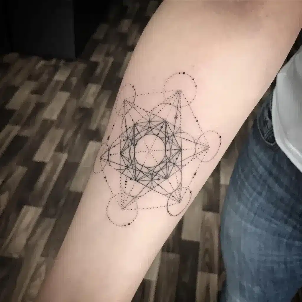 A forearm tattoo of a cube