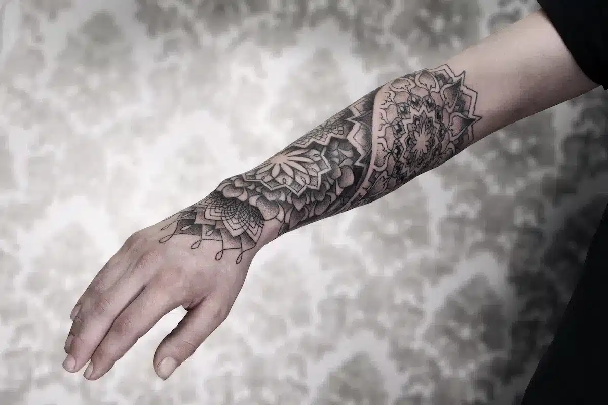 Forearm wrapped in black ink tattoo