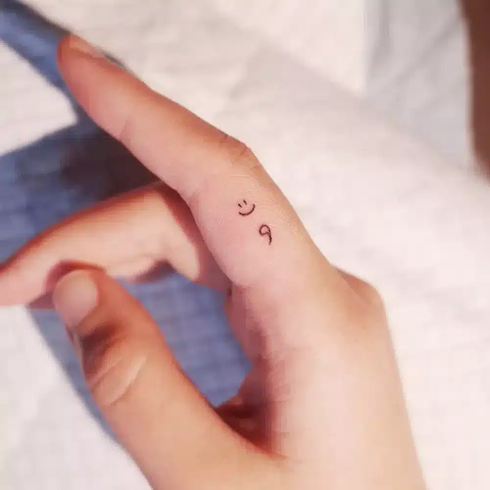 Semicolon finger tattoo